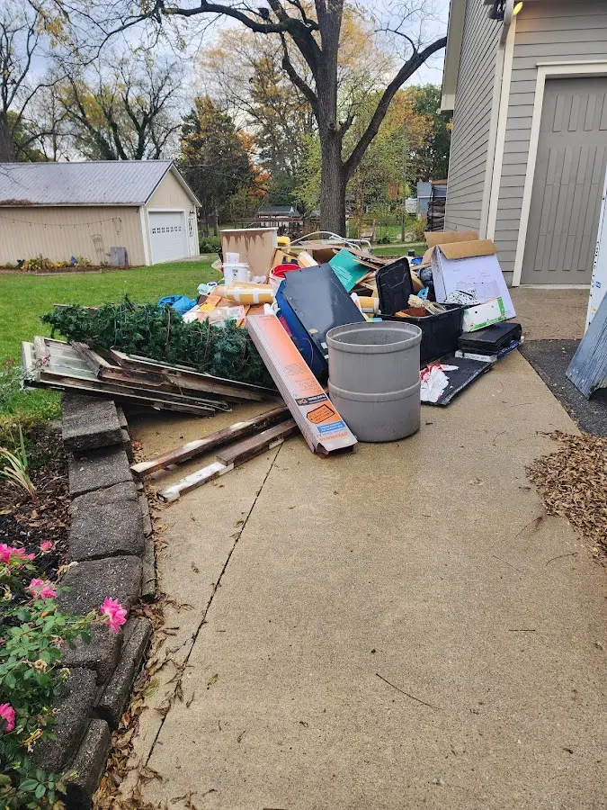 Dumpster being loaded with debris for Estate Cleanout Dumpster Rental in Maywood